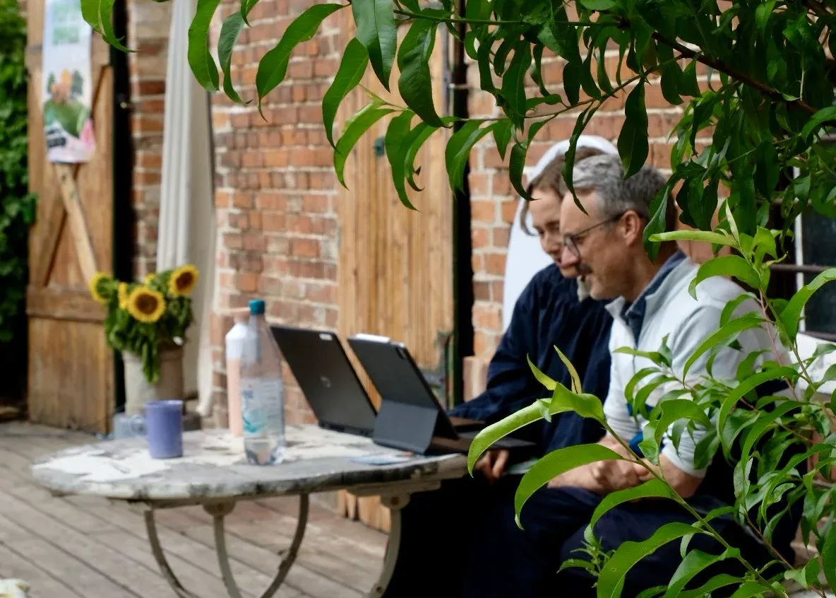 Zwei Personen schauen zusammen in einen Laptop